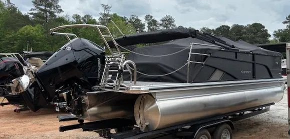 Slide: The Image of 2025 Crest Classic 220 pontoon boat on trailer, covered and ready for transport. - 12