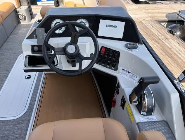 Slide: The Image of 2025 Crest Classic 220 boat dashboard with steering wheel and control panel. - 3