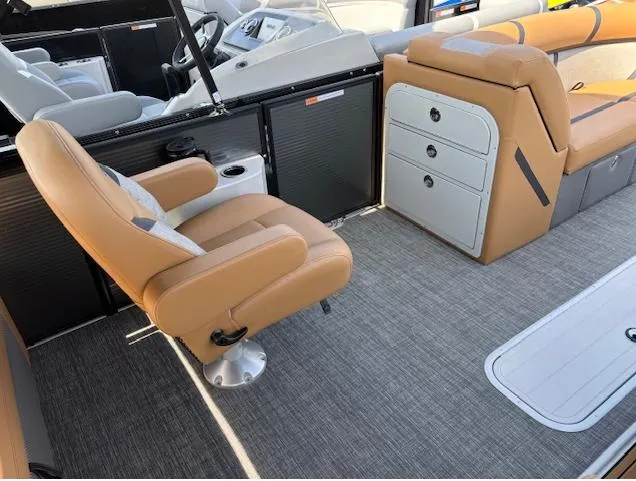 Slide: The Image of 2025 Crest Classic 220 boat interior with tan seating and modern dashboard. - 4