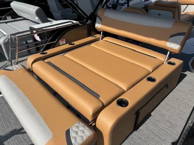Slide: The Image of Luxurious seating on 2025 Crest Classic 220 pontoon boat with tan upholstery and cup holders. - 5