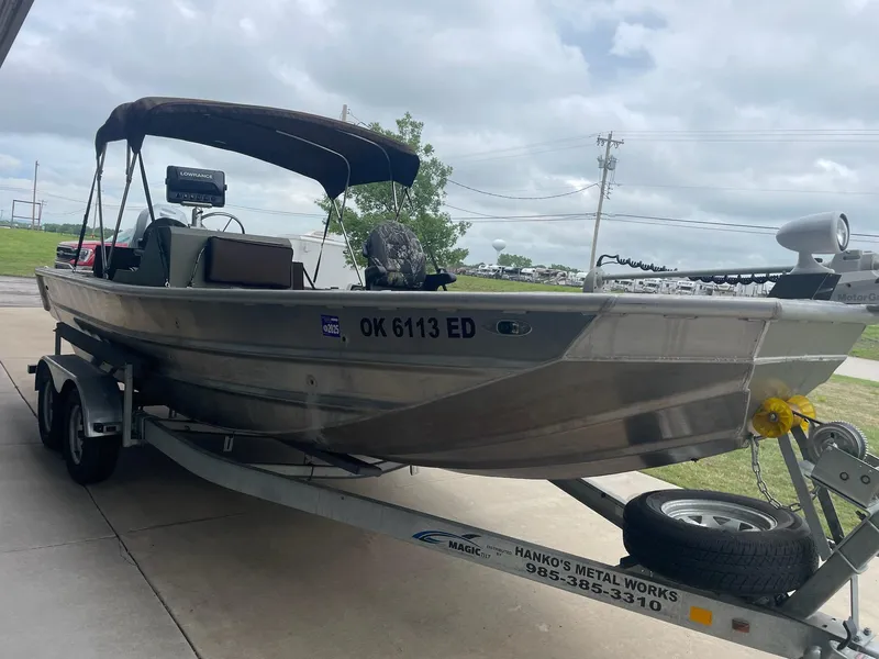 Slide: The Image of 2016 Hanko 20-6 boat on trailer, parked outdoors under cloudy sky. - 2