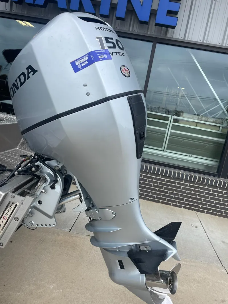 Slide: The Image of Silver Honda 150 outboard motor on a Hanko 20-6 boat, 2016 model, outside a marine shop. - 5