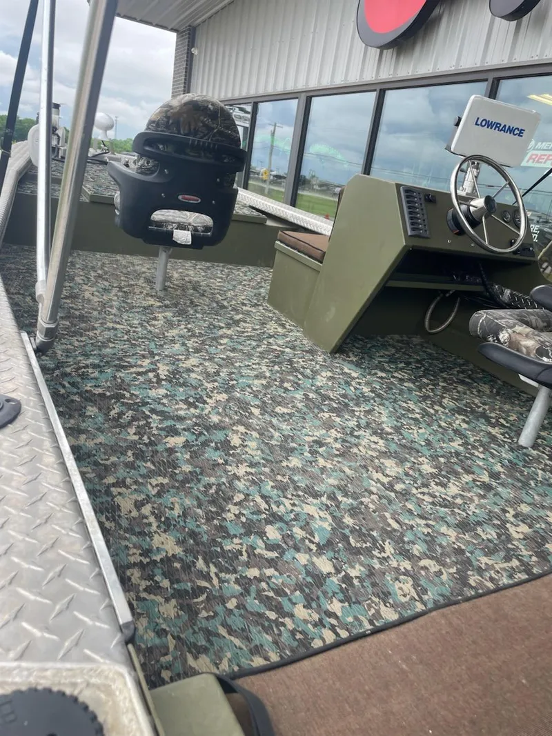 Slide: The Image of Interior of a 2016 Hanko 20-6 boat with camo flooring and Lowrance equipment. - 6