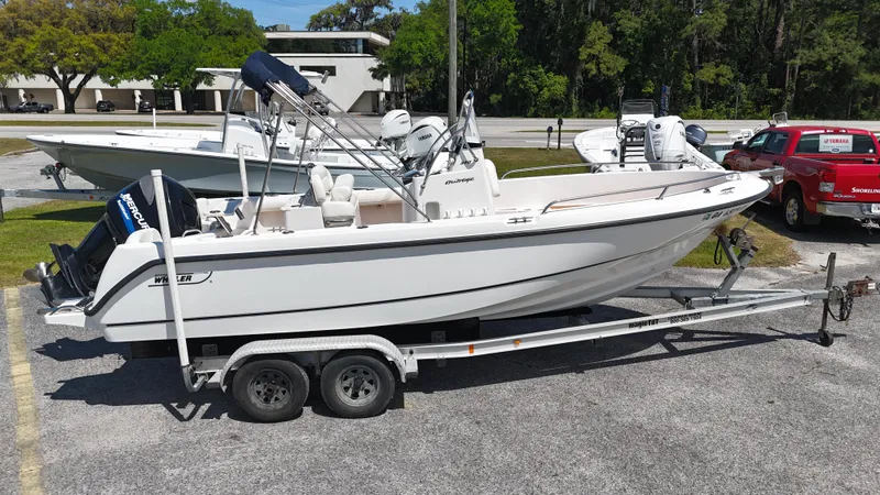 Slide: The Image of 2003 Boston Whaler 21 Outrage boat on trailer in parking lot. - 2