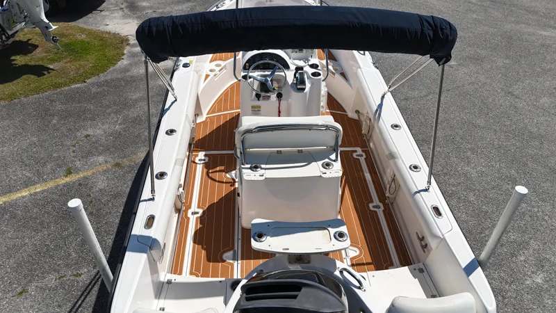 Slide: The Image of 2003 Boston Whaler 21 Outrage boat with teak flooring and canopy, viewed from above. - 8
