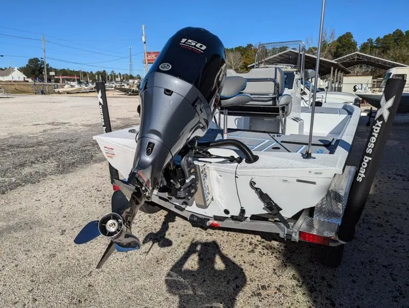 Slide: The Image of 2025 Xpress H210B boat with Yamaha 150 engine, parked on a trailer. - 10