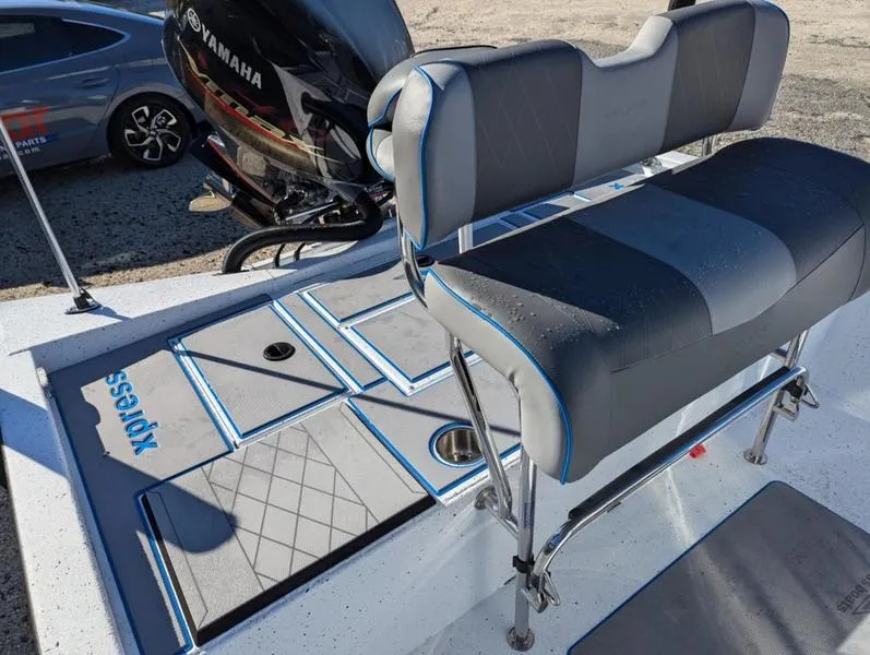 Slide: The Image of 2025 Xpress H210B boat interior with Yamaha engine, featuring cushioned seating and non-slip flooring. - 12