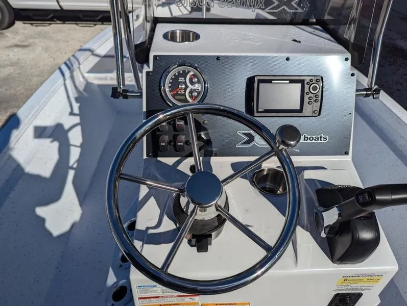 Slide: The Image of Steering console of 2025 Xpress H210B boat with gauges and controls. - 4