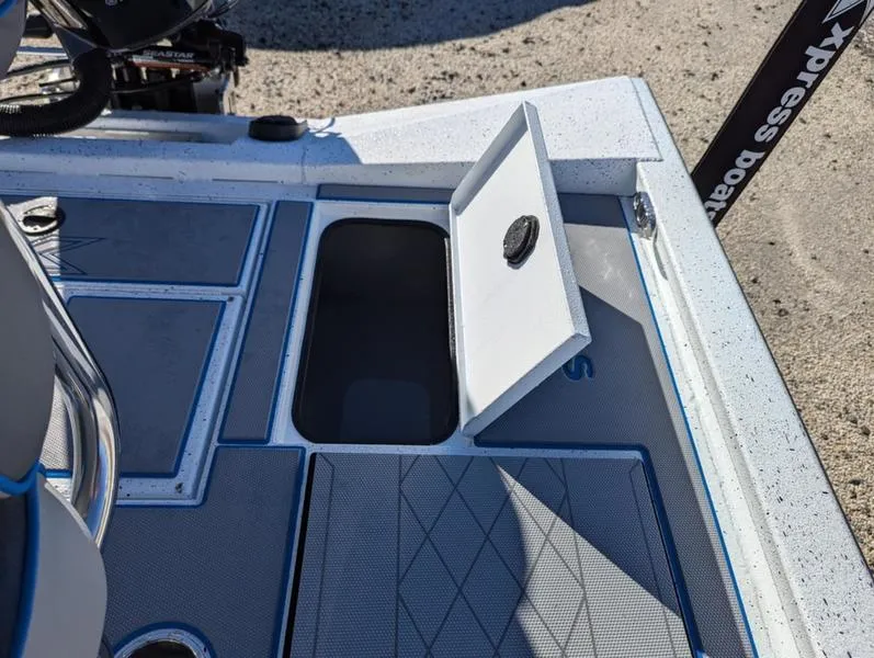 Slide: The Image of 2025 Xpress H210B boat deck with open storage compartment, showcasing modern design and functionality. - 5