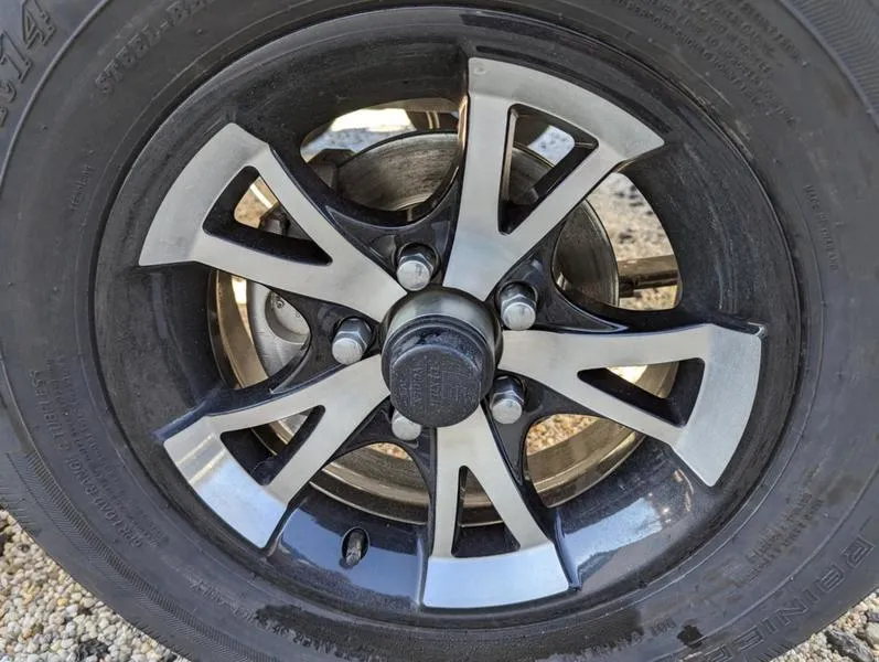 Slide: The Image of 2025 Xpress H210B wheel with sleek black and silver alloy design. - 6