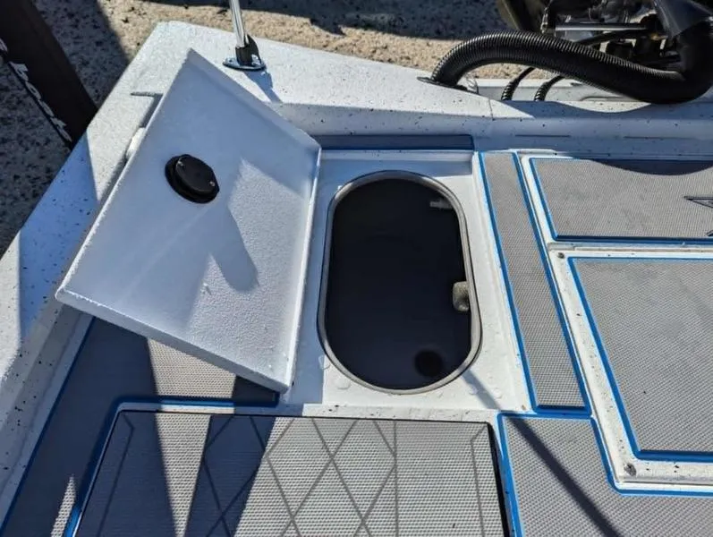 Slide: The Image of 2025 Xpress H210B boat storage compartment with open hatch, showcasing interior space. - 9
