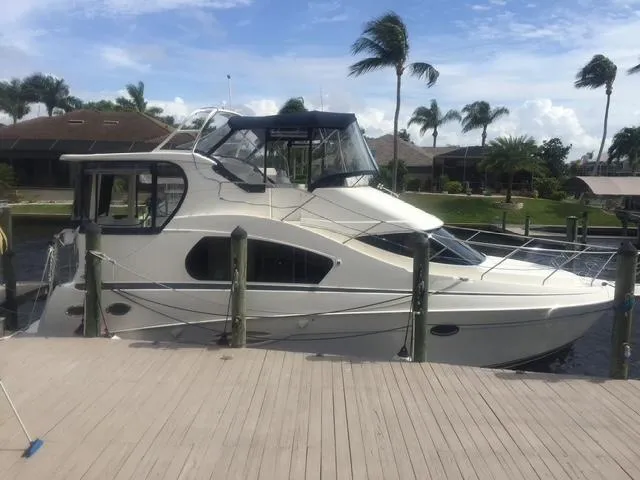 The Image of 2003 Silverton 35 MY yacht docked at marina with nearby boats and buildings. - 0