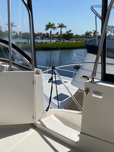 Slide: The Image of 2003 Silverton 35 MY boat interior with dual gray captain's chairs. - 12