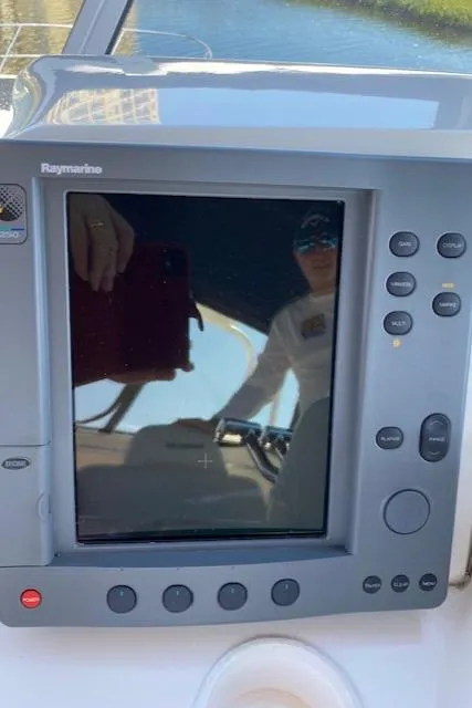 Slide: The Image of 2003 Silverton 35 MY yacht docked by a scenic waterfront with palm trees. - 13