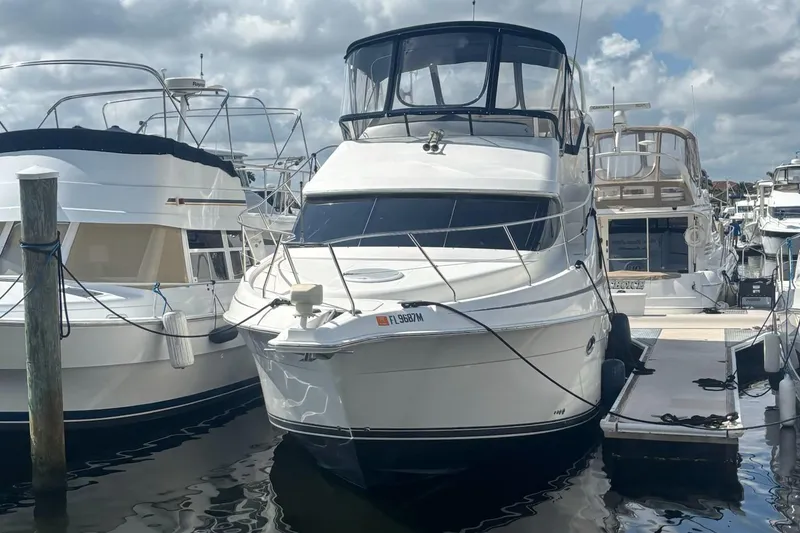 Slide: The Image of 2003 Silverton 35 MY yacht docked at marina under cloudy sky. - 2