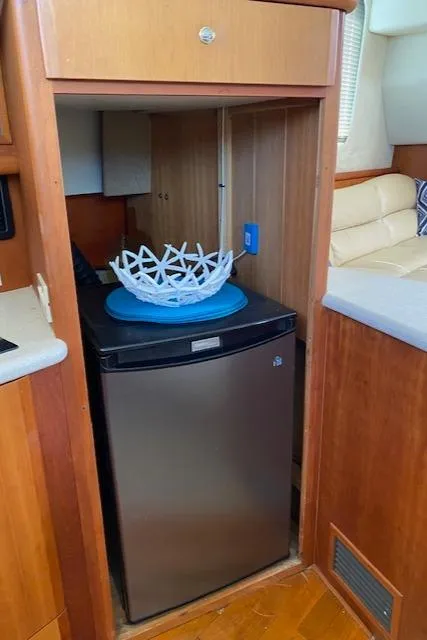 Slide: The Image of 2003 Silverton 35 MY yacht kitchen with wood cabinets, sink, microwave, and coffee maker. - 27