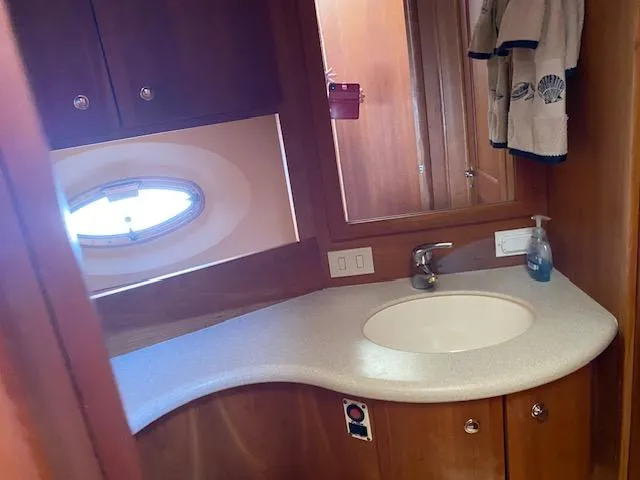 Slide: The Image of Interior of 2003 Silverton 35 MY yacht with wooden cabinetry and small sink. - 30