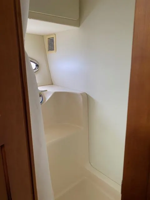 Slide: The Image of 2003 Silverton 35 MY yacht bathroom with porthole and shower area. - 32