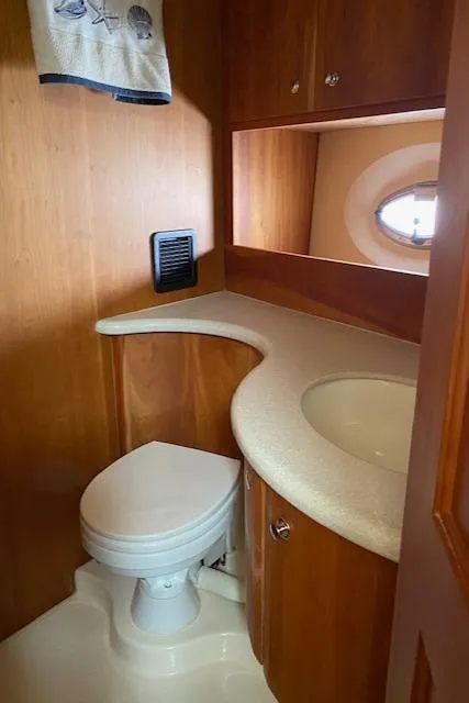 Slide: The Image of 2003 Silverton 35 MY yacht bathroom with wooden cabinetry and modern sink. - 34