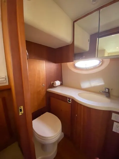 Slide: The Image of 2003 Silverton 35 MY yacht bathroom with shower, sink, and mirror. - 47