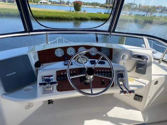 Slide: The Image of 2003 Silverton 35 MY yacht interior with marina view through windows. - 5