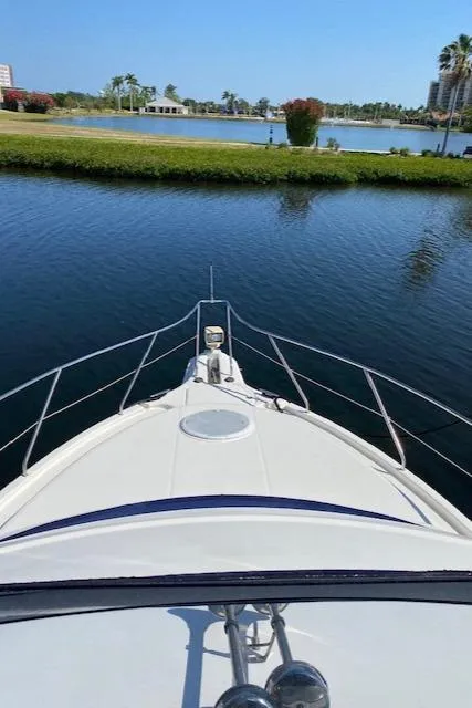 Slide: The Image of 2003 Silverton 35 MY boat interior with white leather seats and cityscape background. - 8