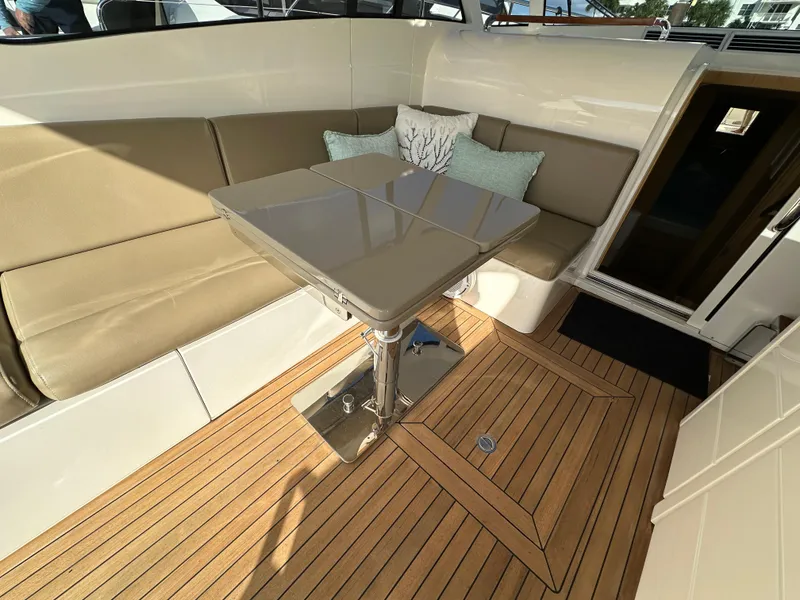 Slide: The Image of 2013 Austin Parker Open 42 yacht interior with beige seating and wooden flooring. - 10