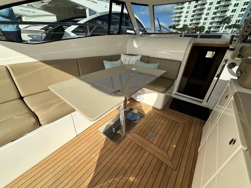Slide: The Image of Luxurious interior of 2013 Austin Parker Open 42 yacht with beige seating and wooden flooring. - 12