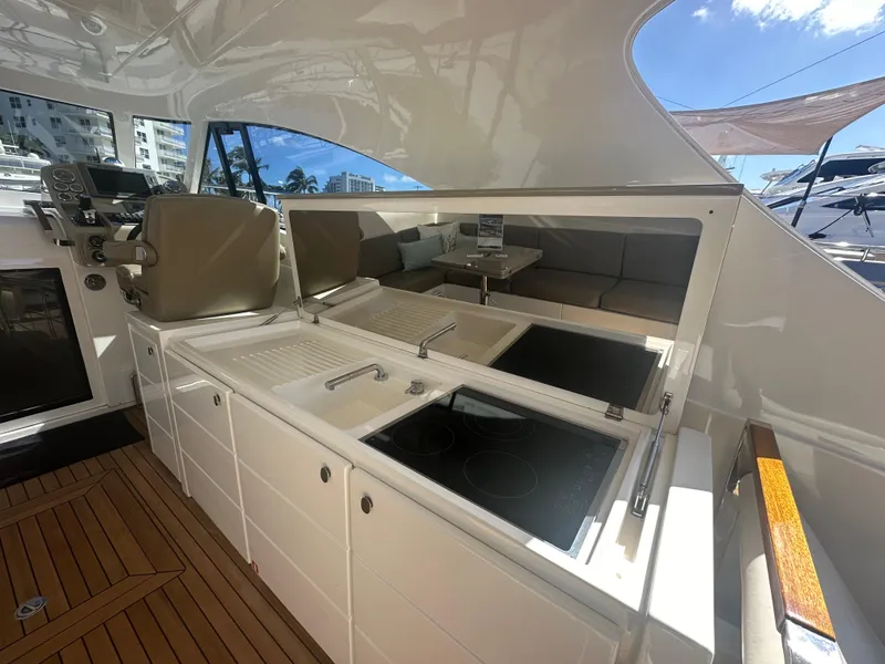 Slide: The Image of Luxurious 2013 Austin Parker Open 42 yacht interior with modern kitchen and seating area. - 13