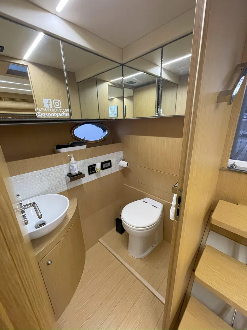 Slide: The Image of Bathroom interior of a 2013 Austin Parker Open 42 yacht, featuring modern fixtures and wood accents. - 24