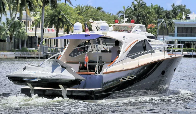 Slide: The Image of 2013 Austin Parker Open 42 yacht cruising on a sunny day with palm trees in the background. - 3