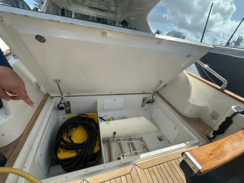 Slide: The Image of Open storage compartment on 2013 Austin Parker Open 42 yacht, featuring coiled cables and equipment. - 35