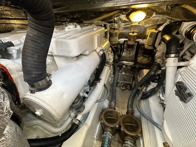 Slide: The Image of Engine room of a 2013 Austin Parker Open 42 yacht, showcasing mechanical components and piping. - 37