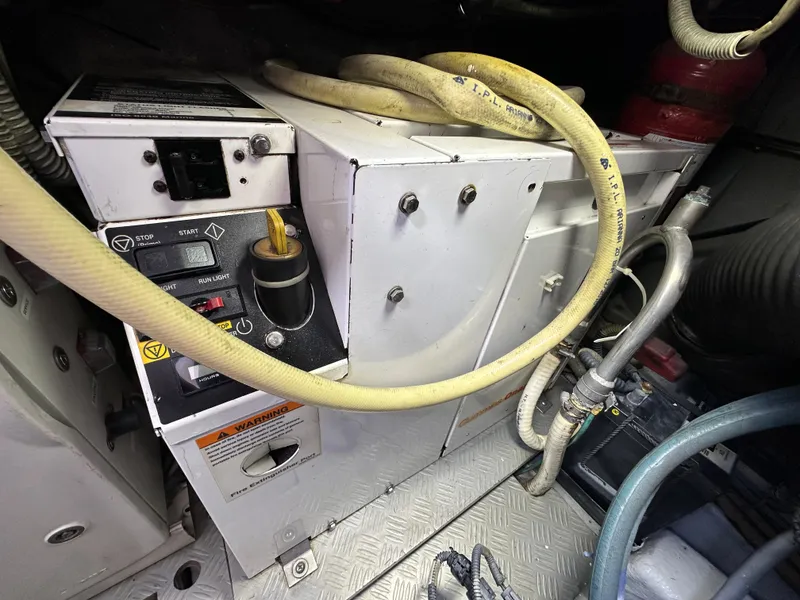 Slide: The Image of Engine compartment of a 2013 Austin Parker Open 42 yacht, featuring hoses and control panel. - 39