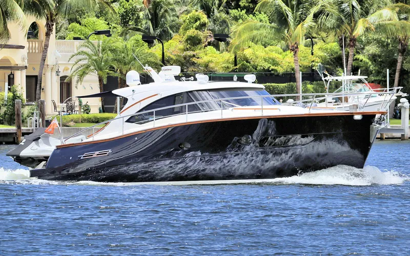 Slide: The Image of 2013 Austin Parker Open 42 yacht cruising on a sunny day, surrounded by lush greenery. - 4