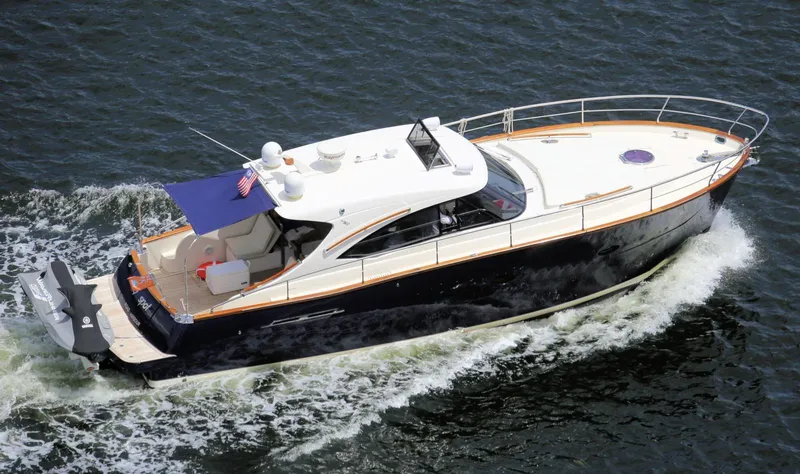 Slide: The Image of Austin Parker Open 42 yacht cruising on water, 2013 model, elegant design, blue canopy. - 6