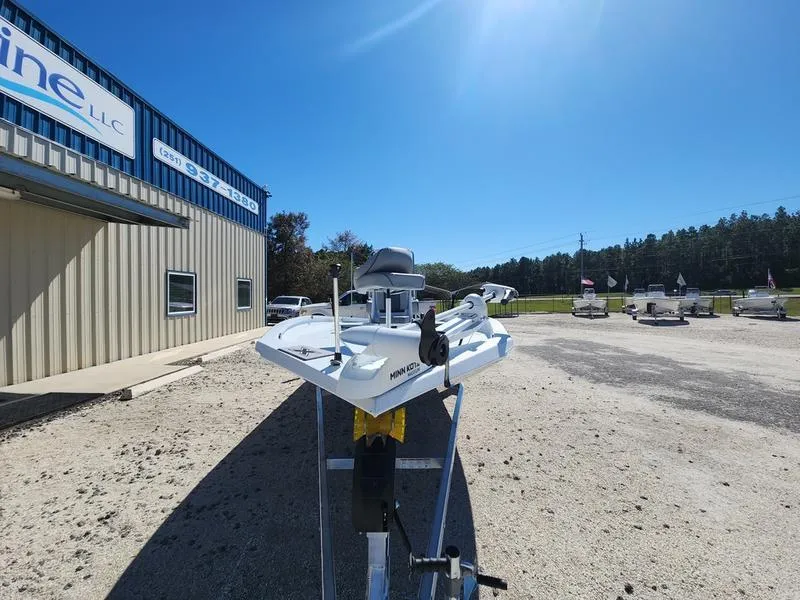 Slide: The Image of 2025 Xpress H22 Bay boat on trailer outside dealership under clear blue sky. - 1