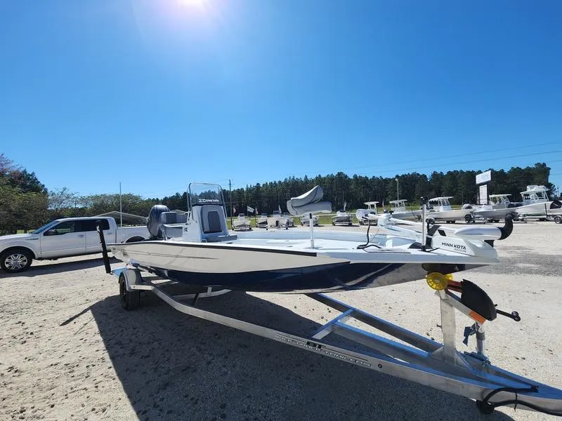 Slide: The Image of 2025 Xpress H22 Bay boat on trailer under clear blue sky. - 11