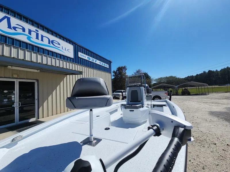Slide: The Image of 2025 Xpress H22 Bay boat displayed outside a marine dealership under a clear blue sky. - 13