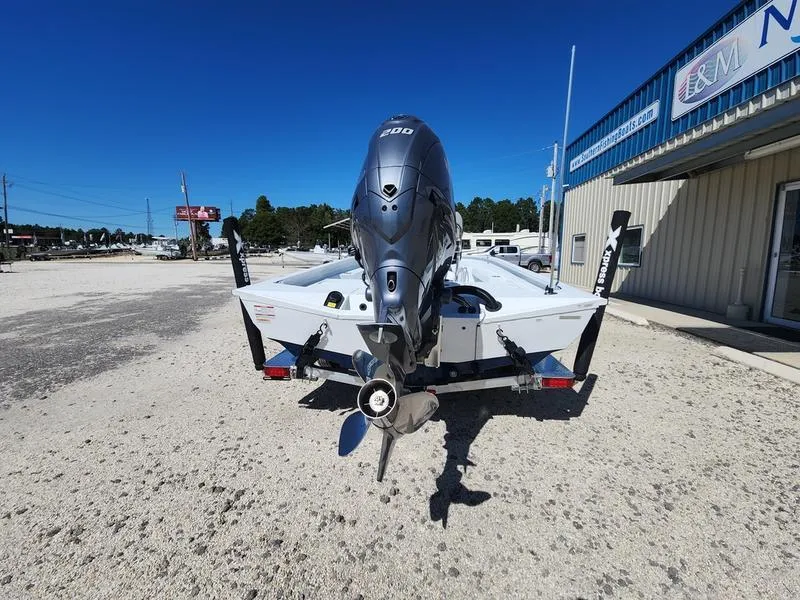 Slide: The Image of 2025 Xpress H22 Bay boat with powerful outboard motor, parked outdoors on a sunny day. - 3