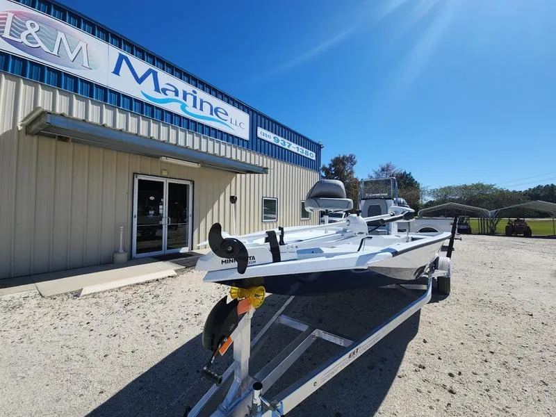 Slide: The Image of 2025 Xpress H22 Bay boat on trailer outside L&M Marine dealership. - 4
