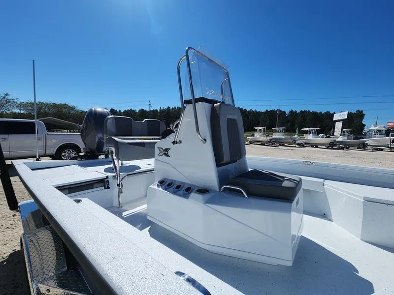 Slide: The Image of 2025 Xpress H22 Bay boat with sleek design and modern console under clear blue sky. - 5