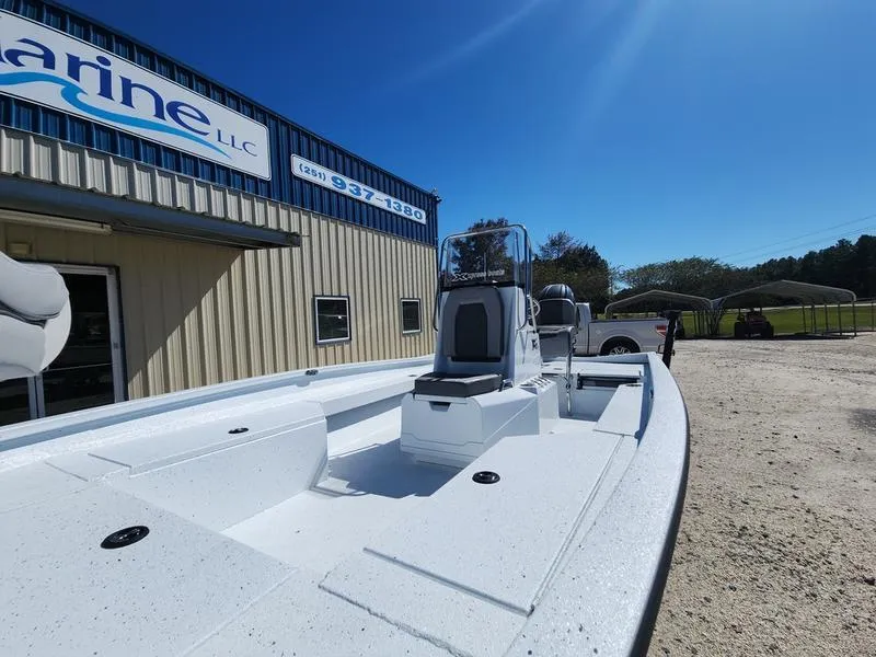 Slide: The Image of 2025 Xpress H22 Bay boat outside a marine dealership under clear blue sky. - 8