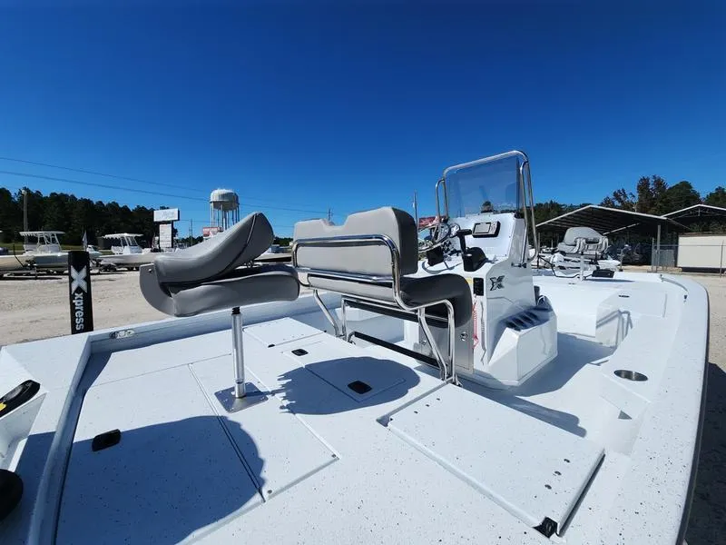 Slide: The Image of 2025 Xpress H22 Bay boat with seating and console, under clear blue sky. - 9