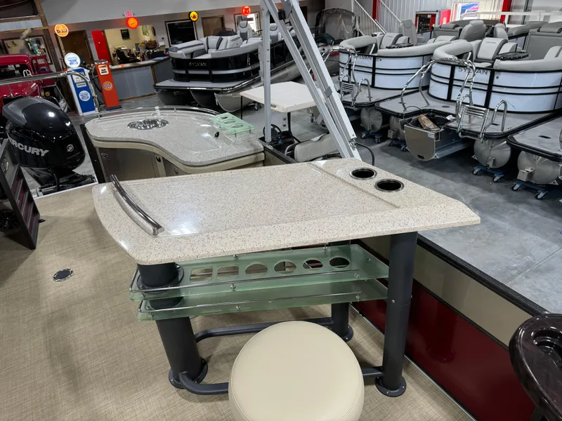 Slide: The Image of 2016 Crest 250 boat interior with bar table and seating in showroom. - 11