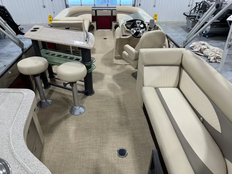 Slide: The Image of Interior of a 2016 Crest 250 boat with beige seating and helm. - 14