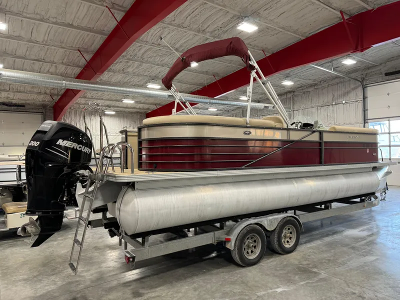 Slide: The Image of 2016 Crest 250 pontoon boat on trailer in indoor storage facility. - 3