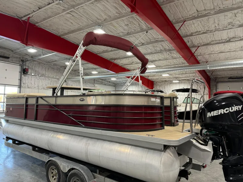 Slide: The Image of 2016 Crest 250 pontoon boat with Mercury engine in a warehouse setting. - 4