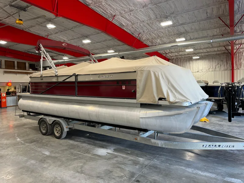Slide: The Image of 2016 Crest 250 pontoon boat on trailer in indoor storage facility. - 6