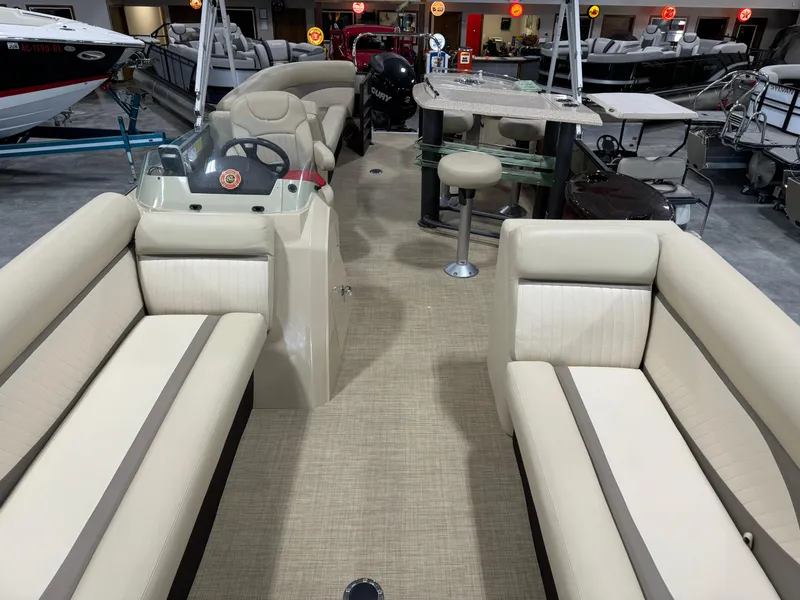Slide: The Image of Interior of a 2016 Crest 250 boat with beige seating and steering console. - 8